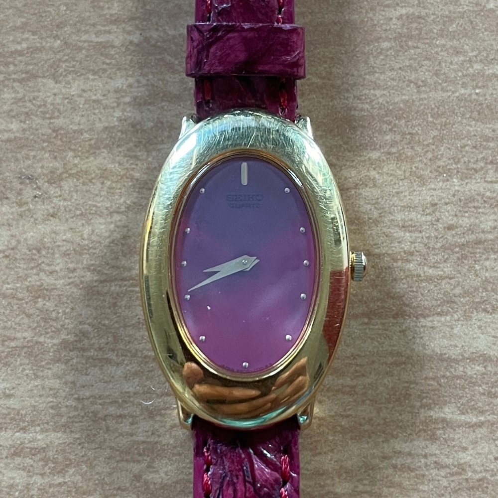 Seiko women’s gold and fuchsia oval faced watch vintage 1981
